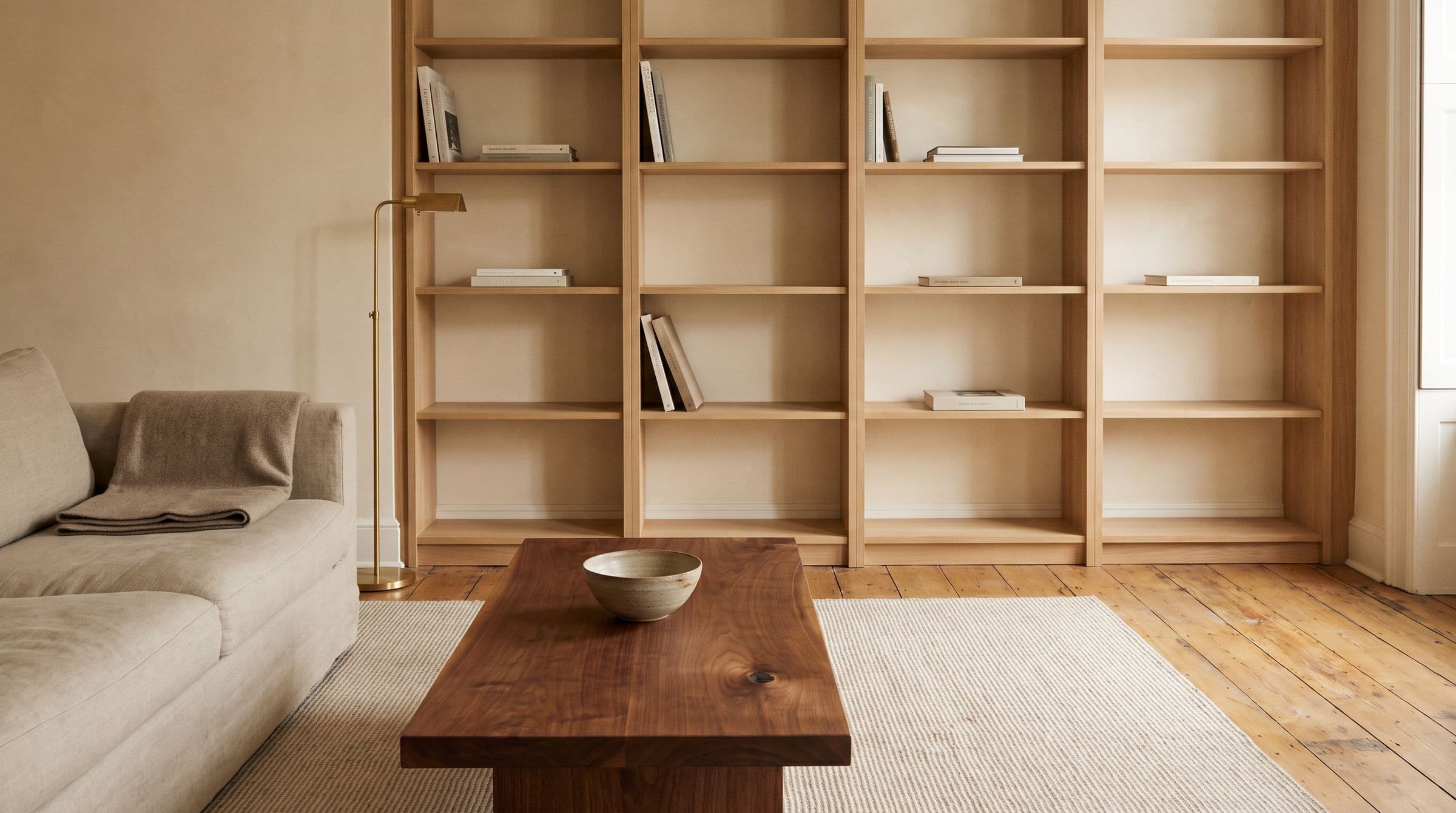 Living room with a built-in white oak bookcase and a solid walnut coffee table